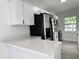 Bright kitchen featuring white cabinets, stainless steel appliances, and quartz countertops at 906 San Domingo Rd, Orlando, FL 32808