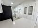 Modern kitchen features white cabinetry, stainless steel appliances, quartz countertops, and a breakfast bar at 906 San Domingo Rd, Orlando, FL 32808