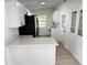 Well-lit kitchen with modern white cabinetry, quartz counters, and a sleek black refrigerator at 906 San Domingo Rd, Orlando, FL 32808