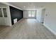 Bright, open living room featuring gray wood-look floors, modern finishes, and large windows at 906 San Domingo Rd, Orlando, FL 32808