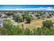 An aerial view capturing a residential neighborhood with tree-lined streets and well-maintained properties at 923 Gascony Ct, Kissimmee, FL 34759
