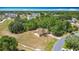 Expansive aerial view of the home with a large yard and mature trees in a residential neighborhood at 923 Gascony Ct, Kissimmee, FL 34759