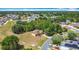Aerial view of single-story home surrounded by lush trees in a residential neighborhood with paved streets at 923 Gascony Ct, Kissimmee, FL 34759