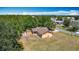 Aerial view of a single-Gathering home with a fenced yard, storage shed, and surrounded by lush greenery at 923 Gascony Ct, Kissimmee, FL 34759