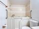 Bathroom featuring an easy-access walk-in bathtub, safety bars, tiled walls and a comfortable toilet at 923 Gascony Ct, Kissimmee, FL 34759