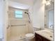 Bathroom featuring a tiled shower, grab bars, toilet, and a vanity with dark wood cabinet at 923 Gascony Ct, Kissimmee, FL 34759