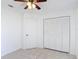 Bright bedroom with tiled flooring, closet doors and ceiling fan at 923 Gascony Ct, Kissimmee, FL 34759