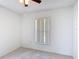 Bright bedroom featuring neutral tile flooring, a ceiling fan, and a window for natural light at 923 Gascony Ct, Kissimmee, FL 34759