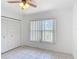 Bright bedroom featuring neutral tile flooring, a closet, and a window allowing natural light at 923 Gascony Ct, Kissimmee, FL 34759