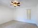 Bright bedroom featuring neutral tile flooring, a ceiling fan, and a window for natural light at 923 Gascony Ct, Kissimmee, FL 34759