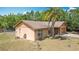 Charming single-story home with a well-maintained lawn and a beautiful palm tree in the front yard at 923 Gascony Ct, Kissimmee, FL 34759