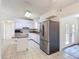 Bright kitchen with white appliances and a large stainless steel refrigerator at 923 Gascony Ct, Kissimmee, FL 34759
