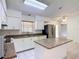 Bright kitchen featuring white cabinets, granite countertops, stainless steel appliances, and a center island at 923 Gascony Ct, Kissimmee, FL 34759