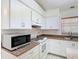 Close up of kitchen with white cabinets, modern appliances, and granite countertops at 923 Gascony Ct, Kissimmee, FL 34759