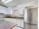 Spacious kitchen with stainless steel refrigerator and a central island at 923 Gascony Ct, Kissimmee, FL 34759