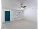 Bright living room with tile floors, ceiling fan, and a dark blue entry door at 923 Gascony Ct, Kissimmee, FL 34759