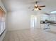 Bright living room area with tile floors, a ceiling fan, and lots of open space at 923 Gascony Ct, Kissimmee, FL 34759
