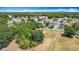 Aerial view of a community with many homes nestled among lush green trees at 923 Gascony Ct, Kissimmee, FL 34759