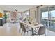 Open-concept dining area with a modern table setting, seamlessly connected to the living room at 1058 Cloud Ridge Ct, Mount Dora, FL 32757