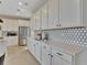Spacious kitchen boasting sleek white cabinets, stainless steel appliances, and ample counter space at 1058 Cloud Ridge Ct, Mount Dora, FL 32757