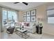 Bright living room featuring a comfortable couch, stylish decor, and plenty of natural light at 1058 Cloud Ridge Ct, Mount Dora, FL 32757