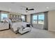 Bright main bedroom featuring a ceiling fan, neutral-toned walls, and a large window with neighborhood views at 1058 Cloud Ridge Ct, Mount Dora, FL 32757