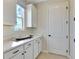 Bright mud room with ample counter space, built-in cabinets, and modern fixtures at 1058 Cloud Ridge Ct, Mount Dora, FL 32757
