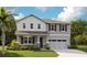 Charming two-story home with stone accents, a well-manicured lawn, and a welcoming covered front porch at 1066 Cloud Ridge Ct, Mount Dora, FL 32757