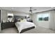 Serene bedroom with a luxurious bed, neutral tones, and large windows providing scenic neighborhood views at 1066 Cloud Ridge Ct, Mount Dora, FL 32757