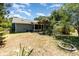 A spacious backyard with a patio, lush greenery, and lawn in need of care at 1100 Anne Elisa Cir, St Cloud, FL 34772