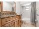Bathroom with wood vanity and granite countertop, and shower-tub combo at 1100 Anne Elisa Cir, St Cloud, FL 34772