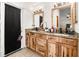 Bathroom featuring a double vanity with wood cabinets and granite countertops at 1100 Anne Elisa Cir, St Cloud, FL 34772