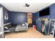 A cozy bedroom featuring navy blue walls, tiled floors, and a ceiling fan at 1100 Anne Elisa Cir, St Cloud, FL 34772
