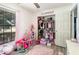 Bedroom with playful decorations, laminate flooring, and a window overlooking the yard at 1100 Anne Elisa Cir, St Cloud, FL 34772