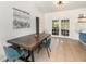 Dining area featuring a rustic wood table, tile floors, and french doors leading to the outside at 1100 Anne Elisa Cir, St Cloud, FL 34772