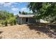 View of the home's exterior featuring a lush tree canopy and leaf covered ground at 1100 Anne Elisa Cir, St Cloud, FL 34772
