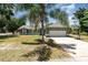 Inviting home featuring a front lawn and a large driveway leading to a two-car garage at 1100 Anne Elisa Cir, St Cloud, FL 34772