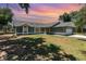 Charming single-story home featuring arched windows, a two-car garage, and a well-maintained lawn at 1100 Anne Elisa Cir, St Cloud, FL 34772
