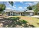 Charming single-story home featuring arched windows, a two-car garage, and a well-maintained lawn at 1100 Anne Elisa Cir, St Cloud, FL 34772