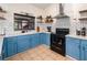 Well-lit kitchen featuring blue cabinets, sleek countertops, and modern appliances at 1100 Anne Elisa Cir, St Cloud, FL 34772