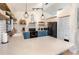Spacious kitchen featuring blue cabinets, quartz countertops, stainless steel appliances, and modern lighting at 1100 Anne Elisa Cir, St Cloud, FL 34772