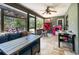 Enclosed sunroom with comfortable seating, ceiling fan, and outdoor views at 1100 Anne Elisa Cir, St Cloud, FL 34772