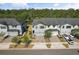 Aerial view of townhomes showing landscaped lawns, paved driveways and garages at 11120 Whistling Pine Way, Orlando, FL 32832