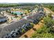 A lovely aerial view of a community of townhomes near a pond and lush landscaping at 11120 Whistling Pine Way, Orlando, FL 32832