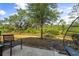 Inviting backyard with mature trees and a relaxing hammock chair, perfect for outdoor enjoyment at 11120 Whistling Pine Way, Orlando, FL 32832