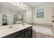 Beautiful bathroom features double sinks, soaking tub, and walk-in shower with glass door at 11120 Whistling Pine Way, Orlando, FL 32832