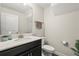 Half-bathroom features a modern vanity, toilet, and neutral-colored walls at 11120 Whistling Pine Way, Orlando, FL 32832