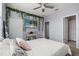 Decorated bedroom with floral accents, a flat screen TV, and an ensuite bathroom at 11120 Whistling Pine Way, Orlando, FL 32832