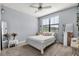 Cozy bedroom with light blue walls, plush carpet, and a well-lit window at 11120 Whistling Pine Way, Orlando, FL 32832