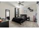 Bedroom featuring a dark bed set, carpeted floor, and a mirror at 11120 Whistling Pine Way, Orlando, FL 32832